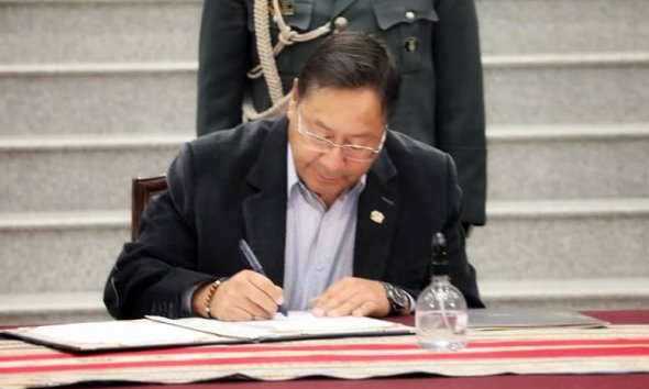 Arce firmando decreto